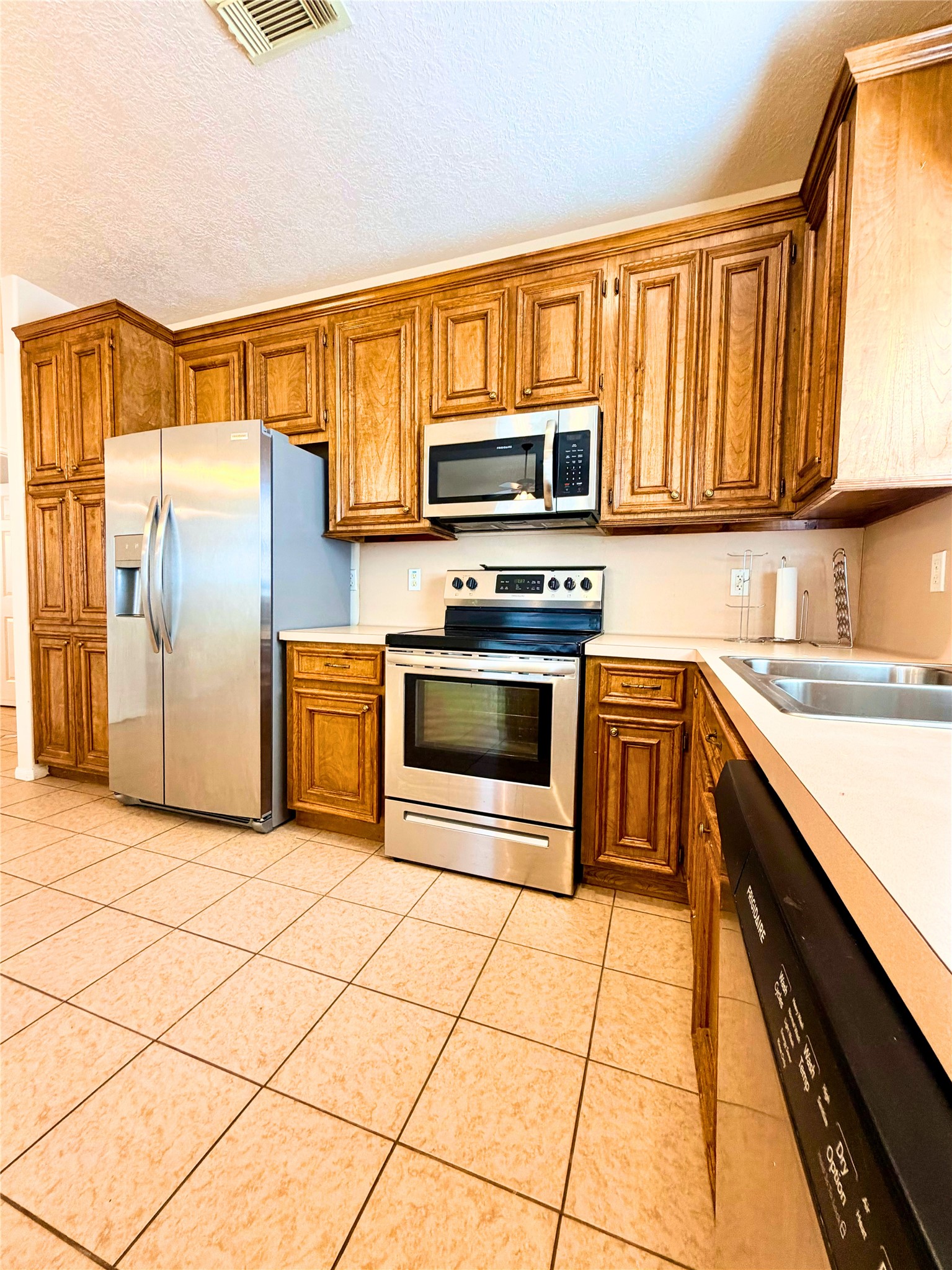 312 Hunt Road, Unit 312 Baytown, TX 77521 - Photo 17 of 28 a kitchen with stainless steel appliances granite countertop a refrigerator and a stove top oven