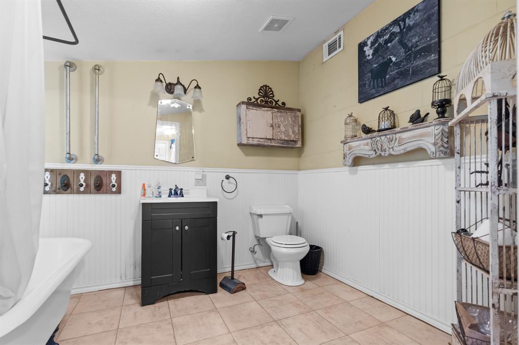 1355 North Houston Street Lorena, TX 76655 - Photo 27 of 40 a bathroom with a toilet sink and mirror