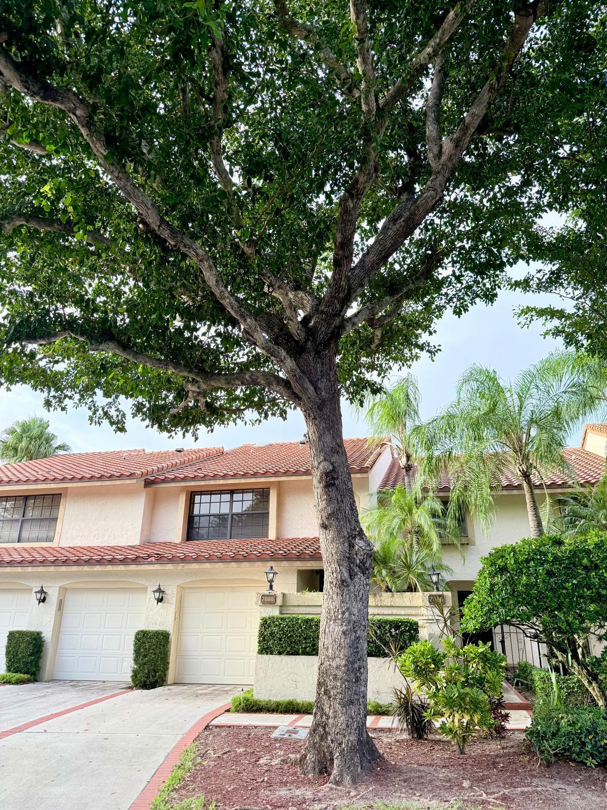 a front view of a house with a garden