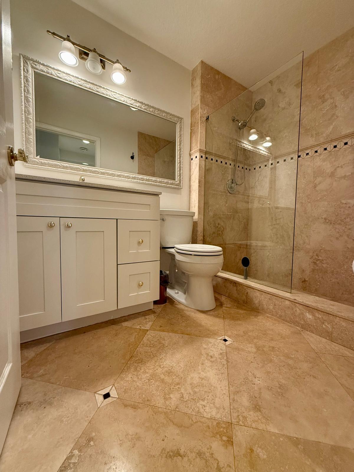 7888 La Mirada Drive Boca Raton, FL 33433 - Photo 11 of 29 a bathroom with a sink a toilet and a mirror