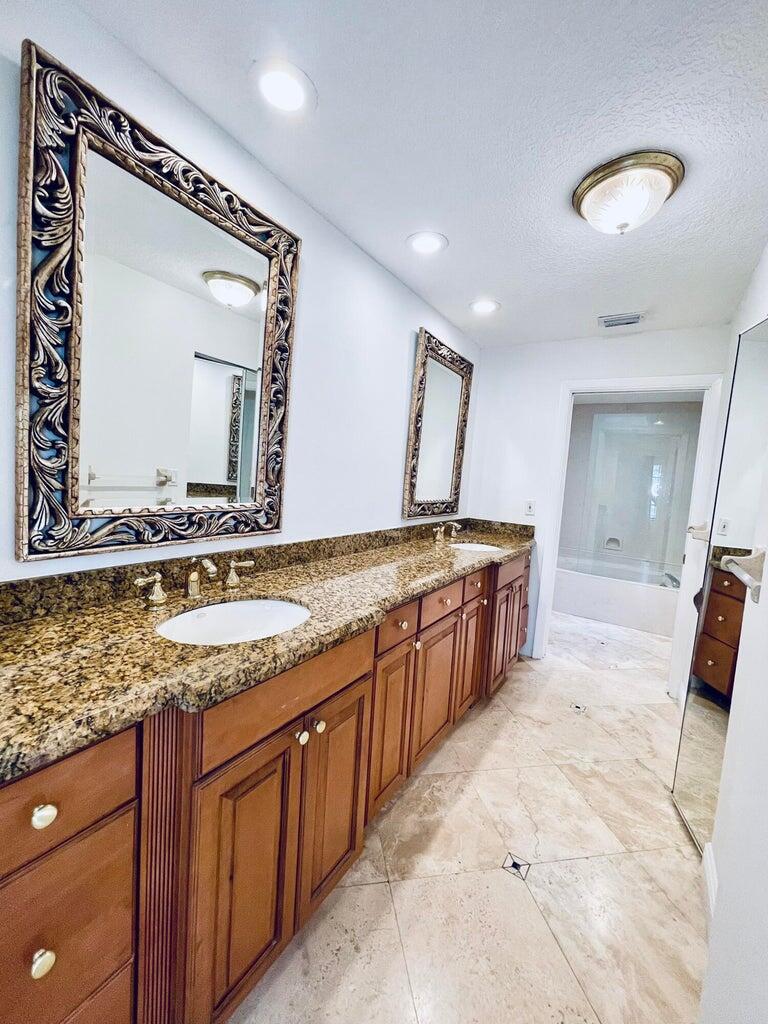 7888 La Mirada Drive Boca Raton, FL 33433 - Photo 15 of 29 a bathroom with a granite countertop sink and a mirror