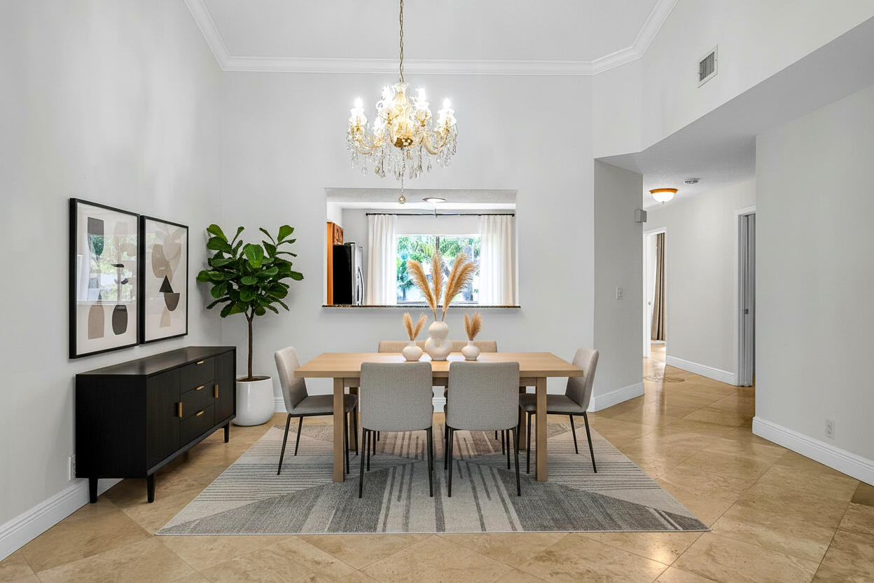 7888 La Mirada Drive Boca Raton, FL 33433 - Photo 19 of 61 a view of a dining room with furniture a chandelier and wooden floor
