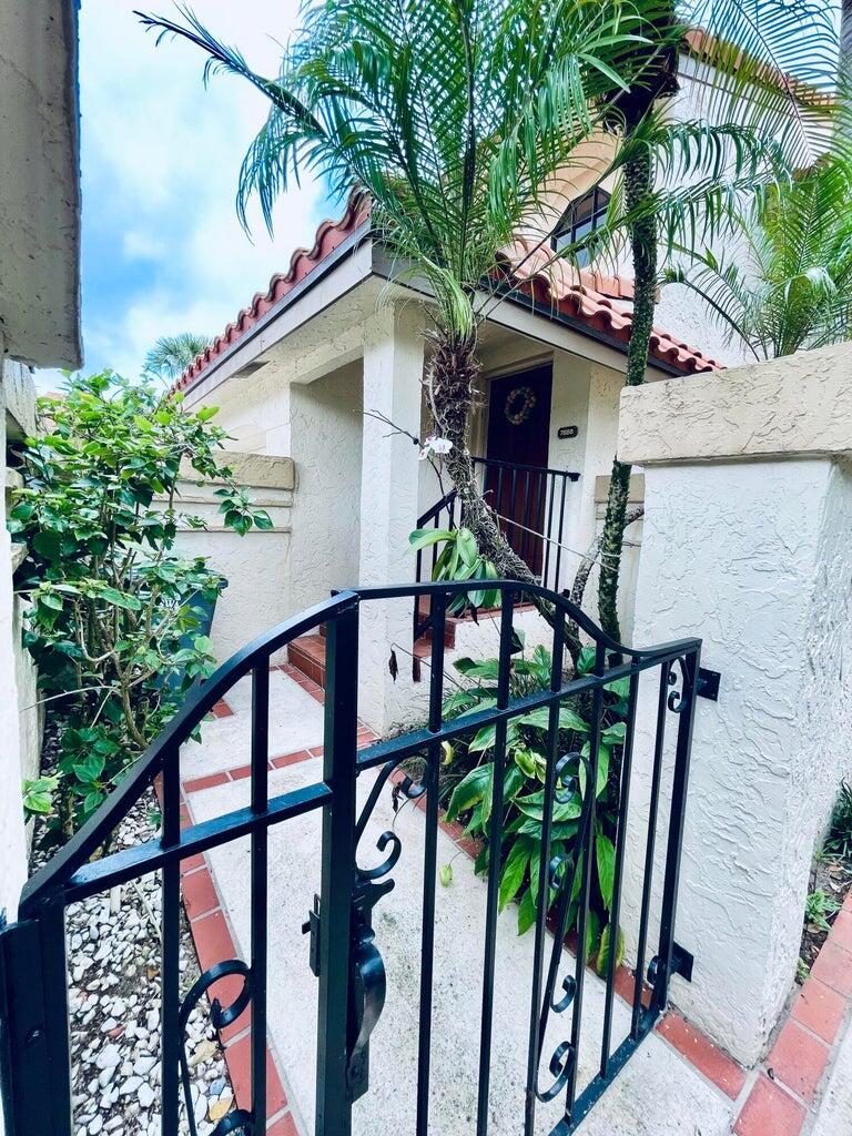 7888 La Mirada Drive Boca Raton, FL 33433 - Photo 2 of 29 a front view of a house with garden