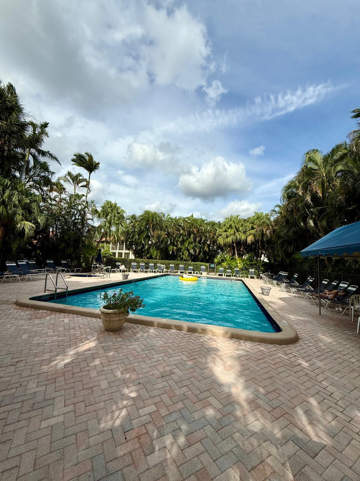 7888 La Mirada Drive Boca Raton, FL 33433 - Photo 29 of 29 a view of swimming pool outdoor seating and lake view