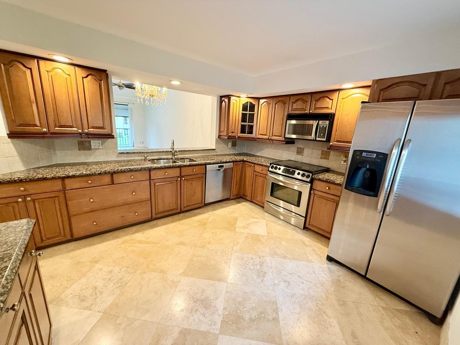 7888 La Mirada Drive Boca Raton, FL 33433 - Photo 4 of 29 a large kitchen with cabinets and wooden floor