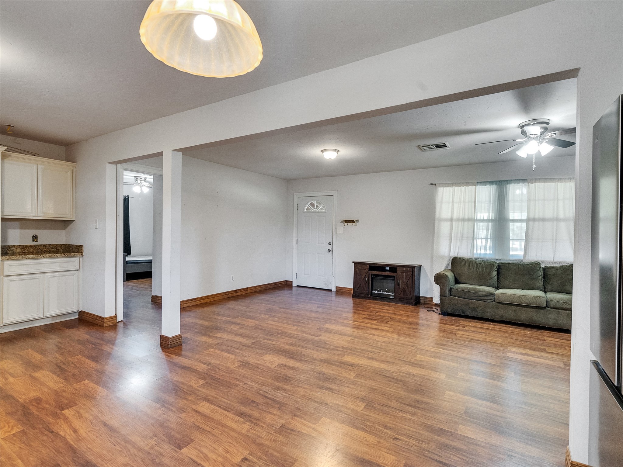 81 Hicks Cleveland, TX 77328 - Photo 11 of 24 a view of a living room a kitchen island wooden floor and a window