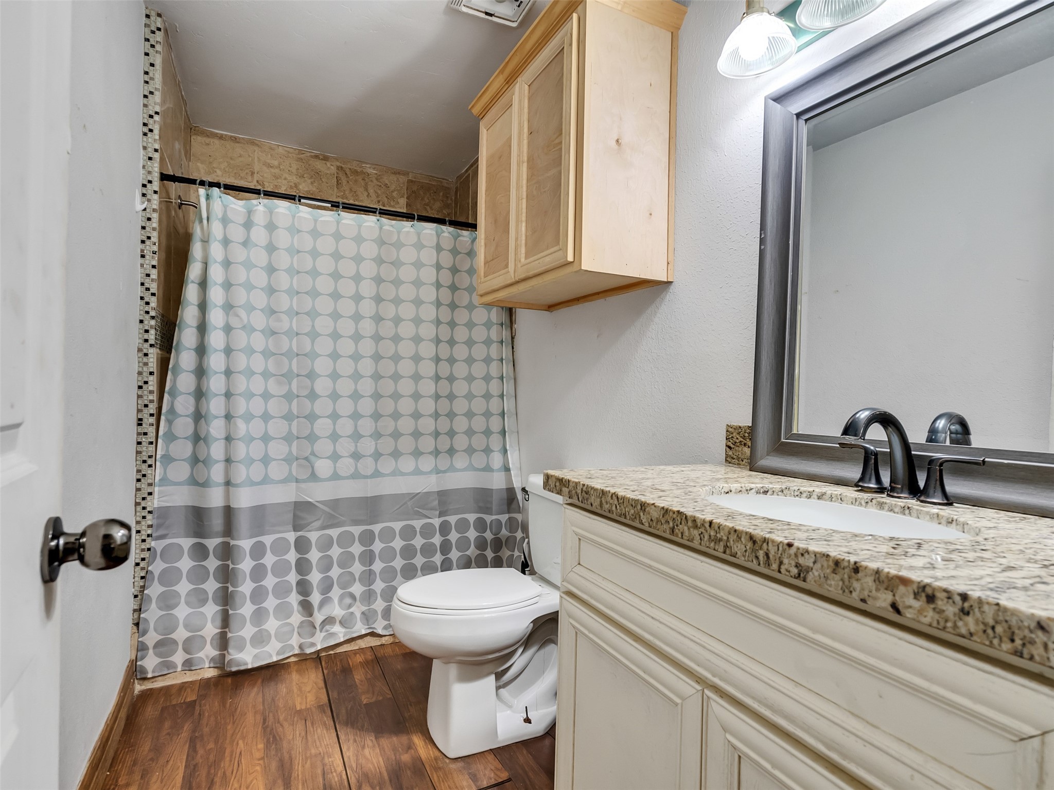 81 Hicks Cleveland, TX 77328 - Photo 12 of 24 a bathroom with a granite countertop toilet sink and mirror