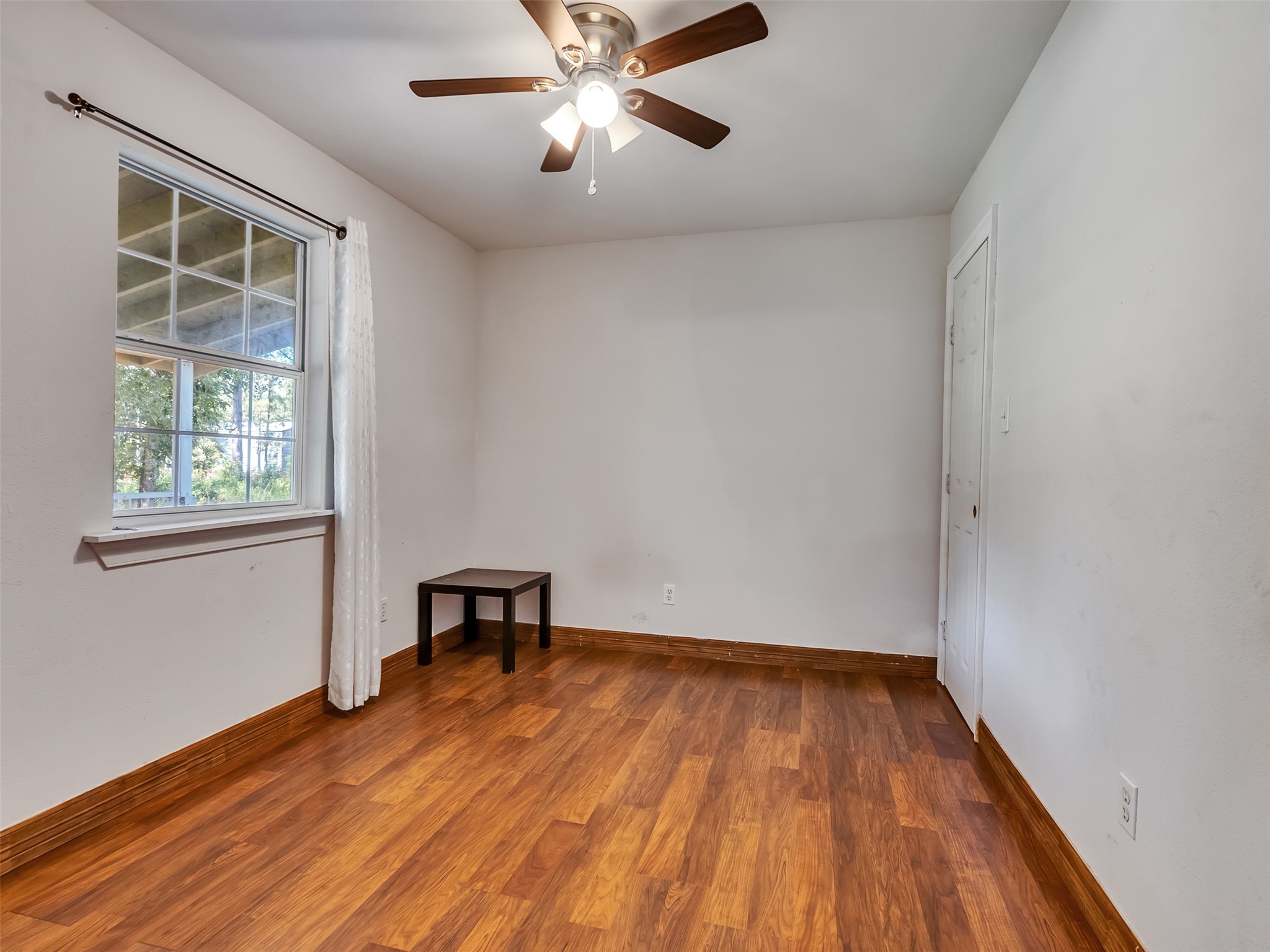 81 Hicks Cleveland, TX 77328 - Photo 13 of 24 wooden floor in an empty room with a window
