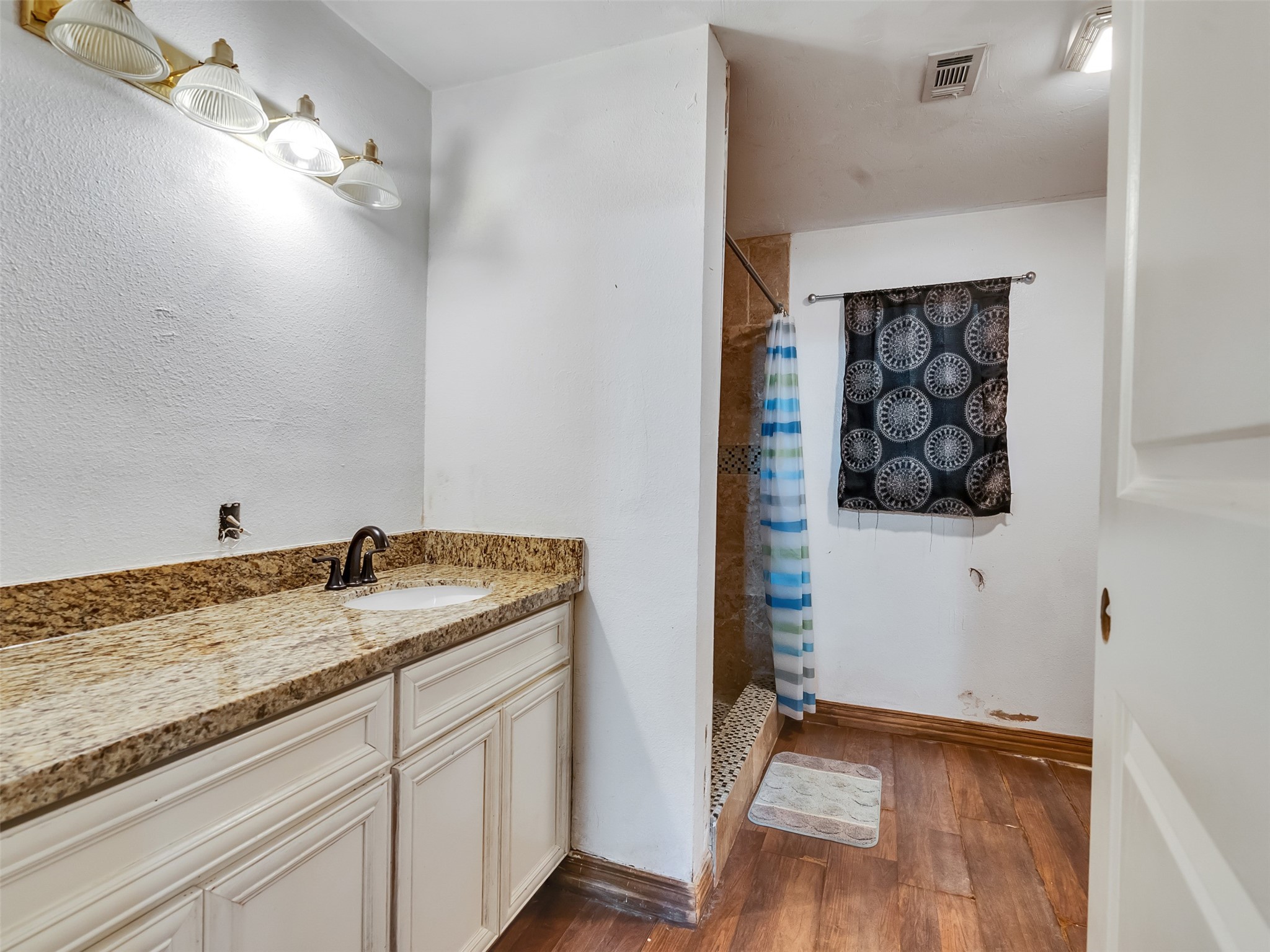 81 Hicks Cleveland, TX 77328 - Photo 8 of 24 a bathroom with a granite countertop sink and a mirror