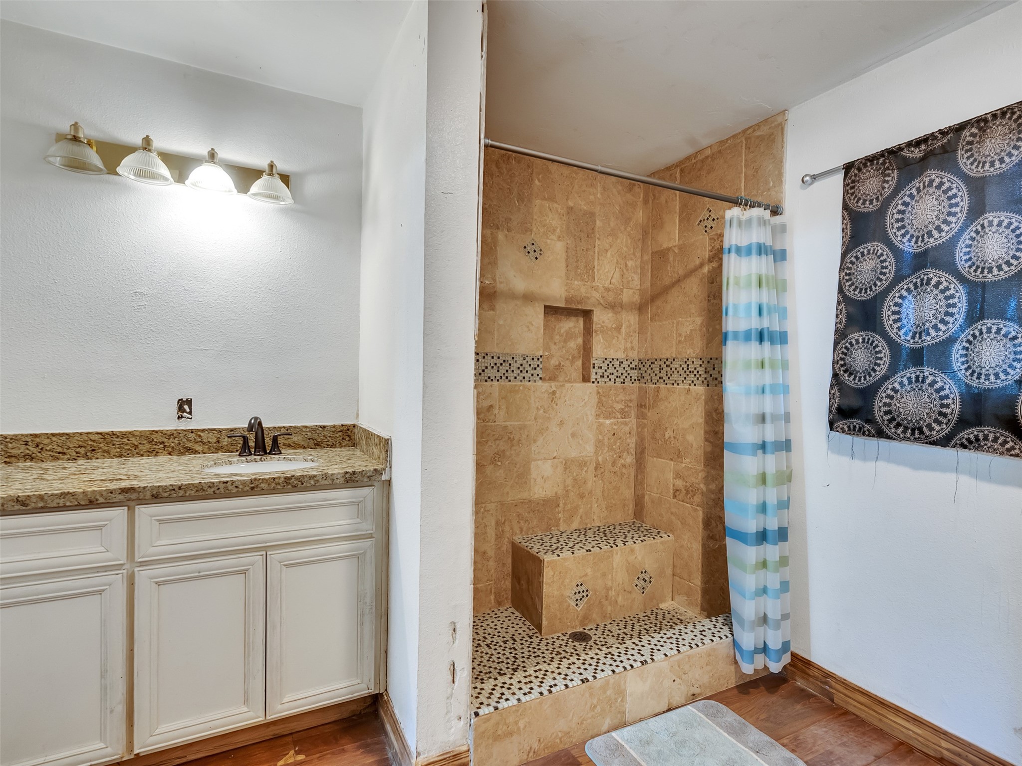 81 Hicks Cleveland, TX 77328 - Photo 9 of 24 a bathroom with a granite countertop sink a shower and a mirror