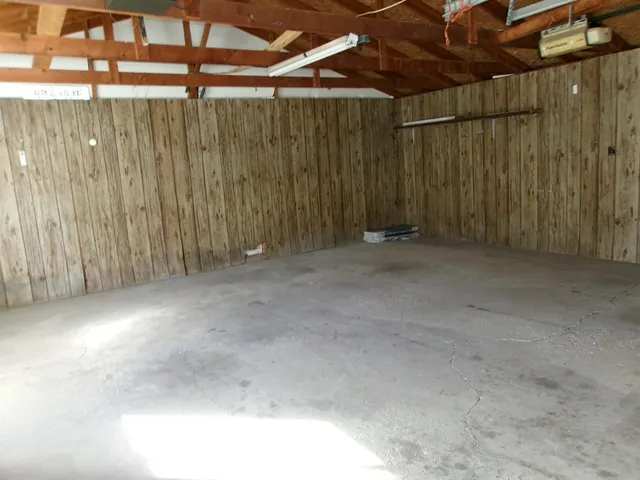 a view of an empty room with wooden walls