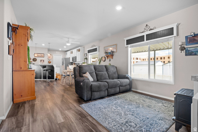 150 West 7500th South, Unit 13 Midvale, UT 84047 - Photo 9 of 32 Open-concept living area featuring wood-finish flooring, recessed lighting, and a large window with custom trim