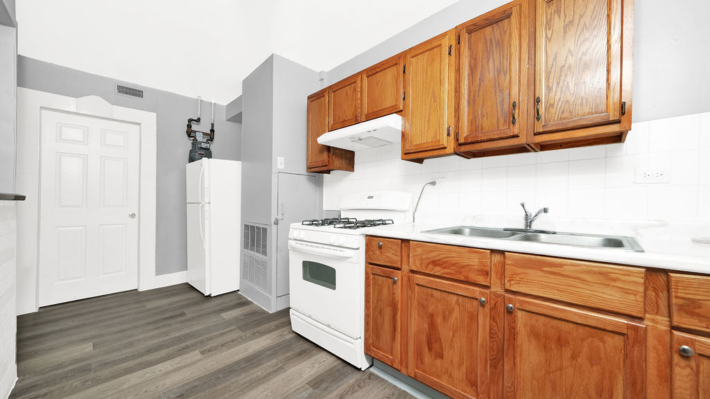 1831 West 21st Place, Unit 1R Chicago, IL 60608 - Photo 6 of 10 a kitchen with stainless steel appliances granite countertop a refrigerator a sink dishwasher and white cabinets with wooden floor