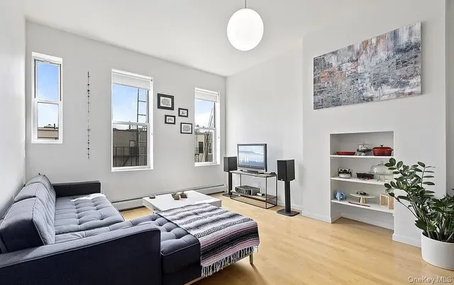 a bedroom with furniture and a potted plant