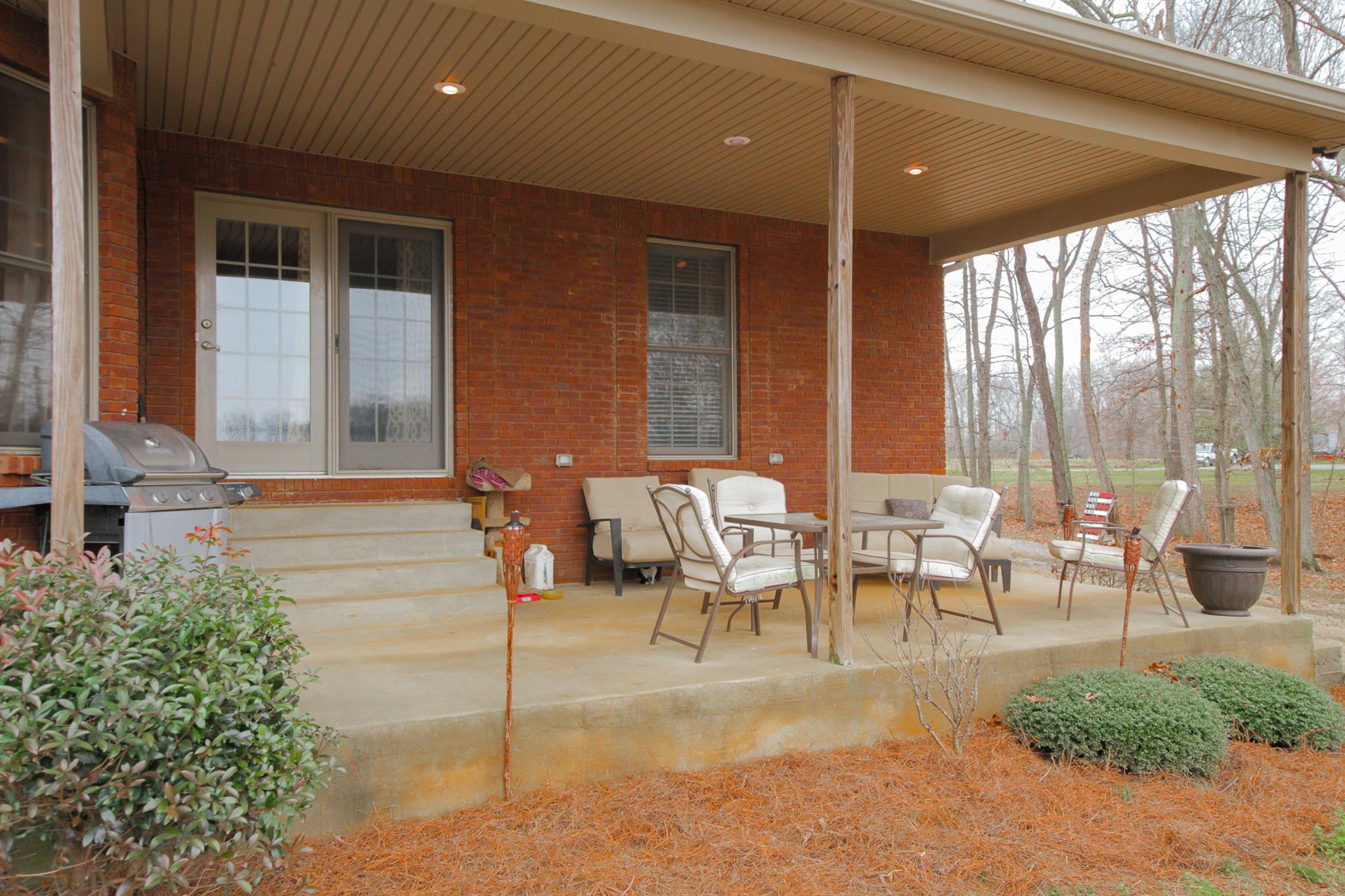 3463 Ott Wilson Road Springfield, TN 37172 - Photo 28 of 30 a view of a patio with table and chairs and floor to ceiling window