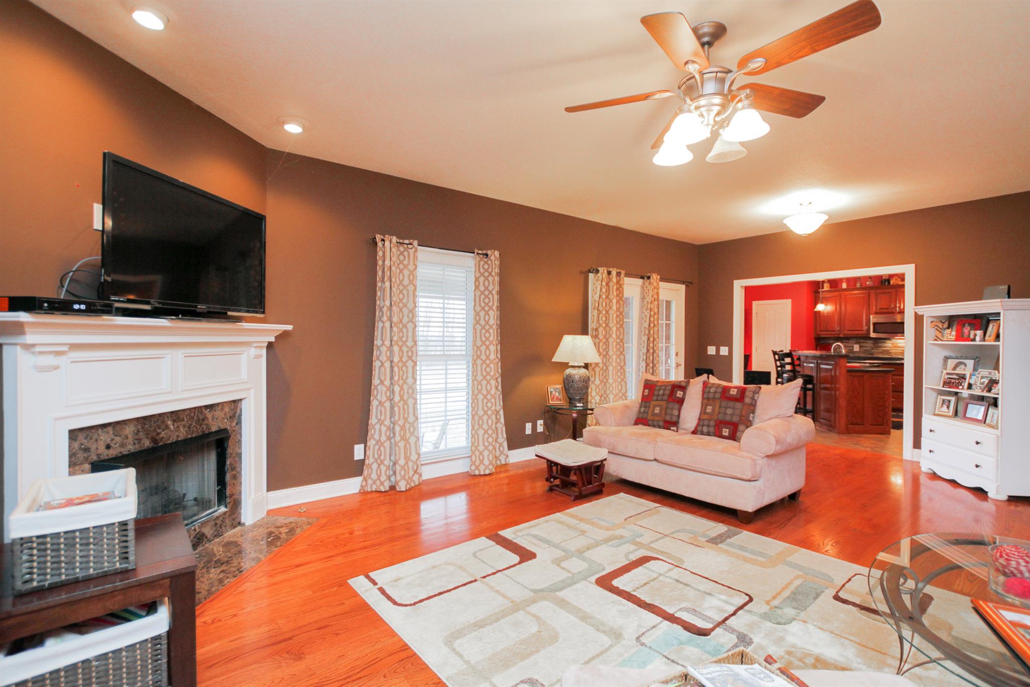 3463 Ott Wilson Road Springfield, TN 37172 - Photo 7 of 30 a living room with furniture a fireplace and a flat screen tv