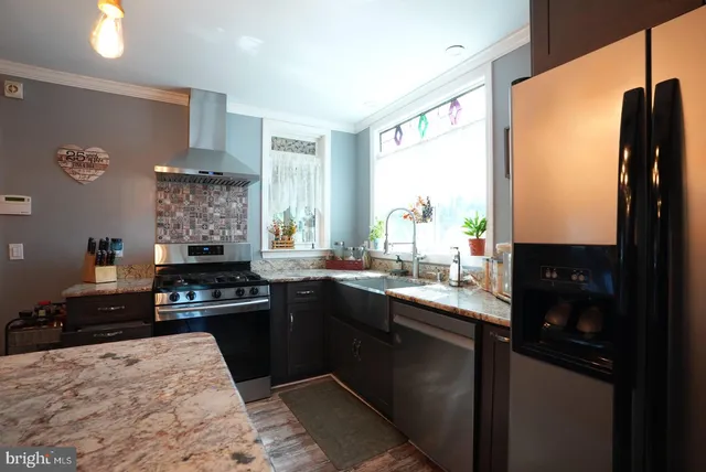 a kitchen with a sink stove and refrigerator