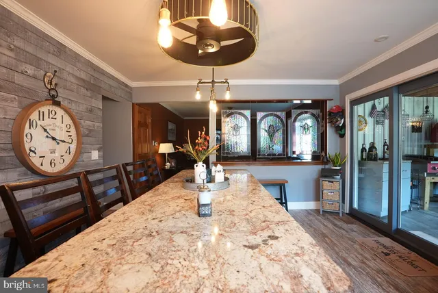 a view of a hallway with wooden floor and a chandelier
