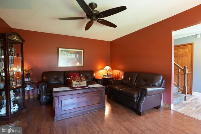 a living room with furniture fireplace and wooden floor