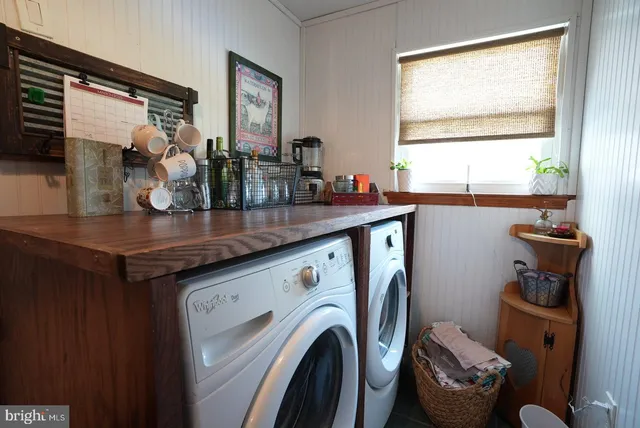 a view of kitchen island with stainless steel appliances granite countertop sink and wooden floor