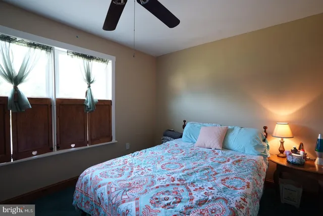 a bedroom with a bed and window