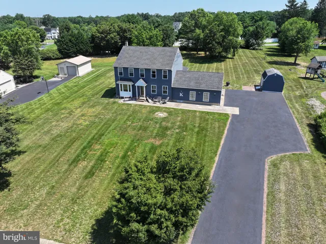 an aerial view of a house with swimming pool and a yard