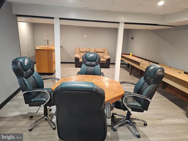 a view of a workspace with furniture and gym equipment