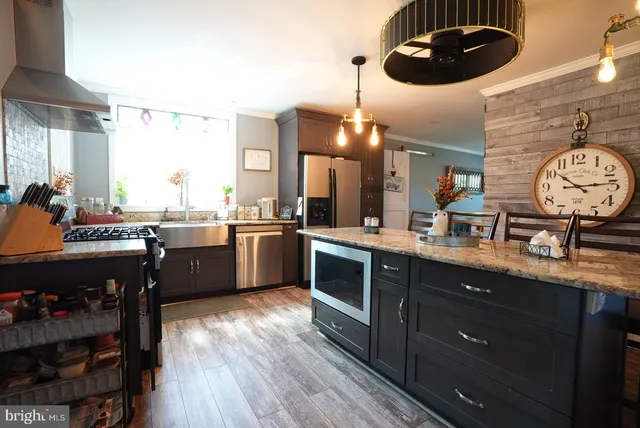 a kitchen with a sink a stove and chairs