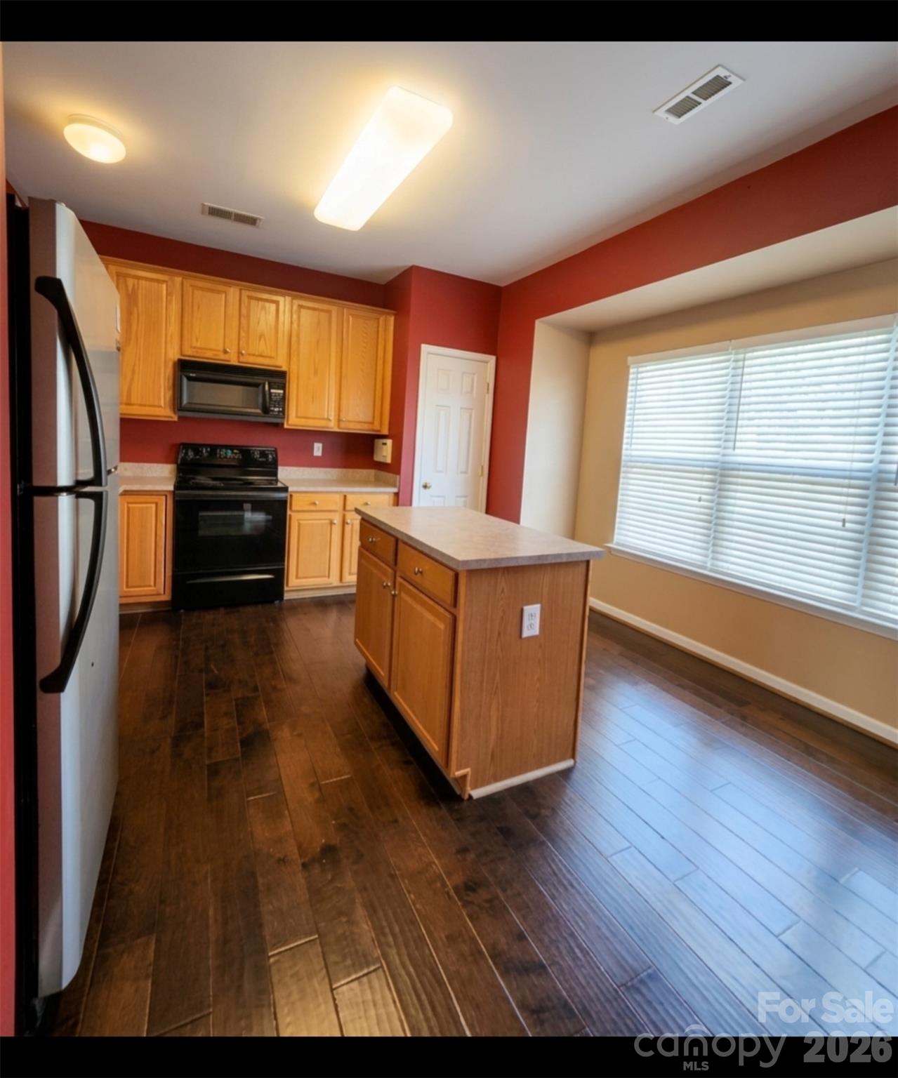 104 Rock Ridge Lane Mount Holly, NC 28120 - Photo 19 of 44 a kitchen with stainless steel appliances wooden floor and a refrigerator