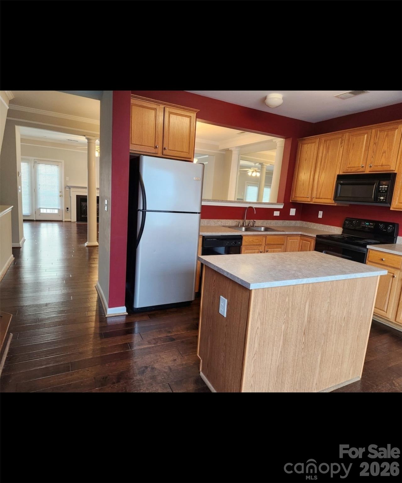 104 Rock Ridge Lane Mount Holly, NC 28120 - Photo 20 of 44 a kitchen with wooden cabinets a stove and a window