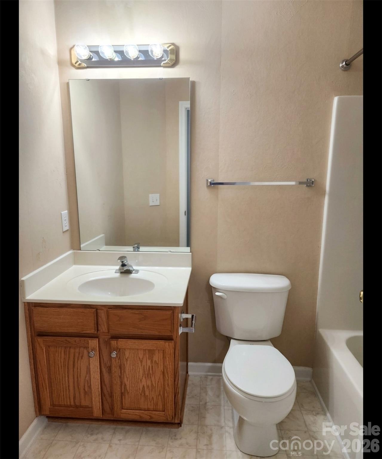 104 Rock Ridge Lane Mount Holly, NC 28120 - Photo 25 of 44 a bathroom with a toilet a sink and a mirror