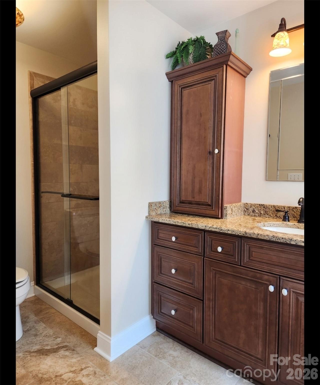 104 Rock Ridge Lane Mount Holly, NC 28120 - Photo 33 of 44 a bathroom with a sink a mirror and a shower