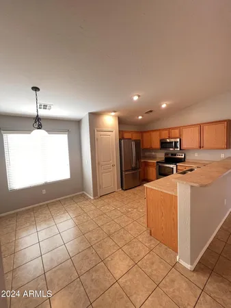 a view of kitchen appliances with cabinets