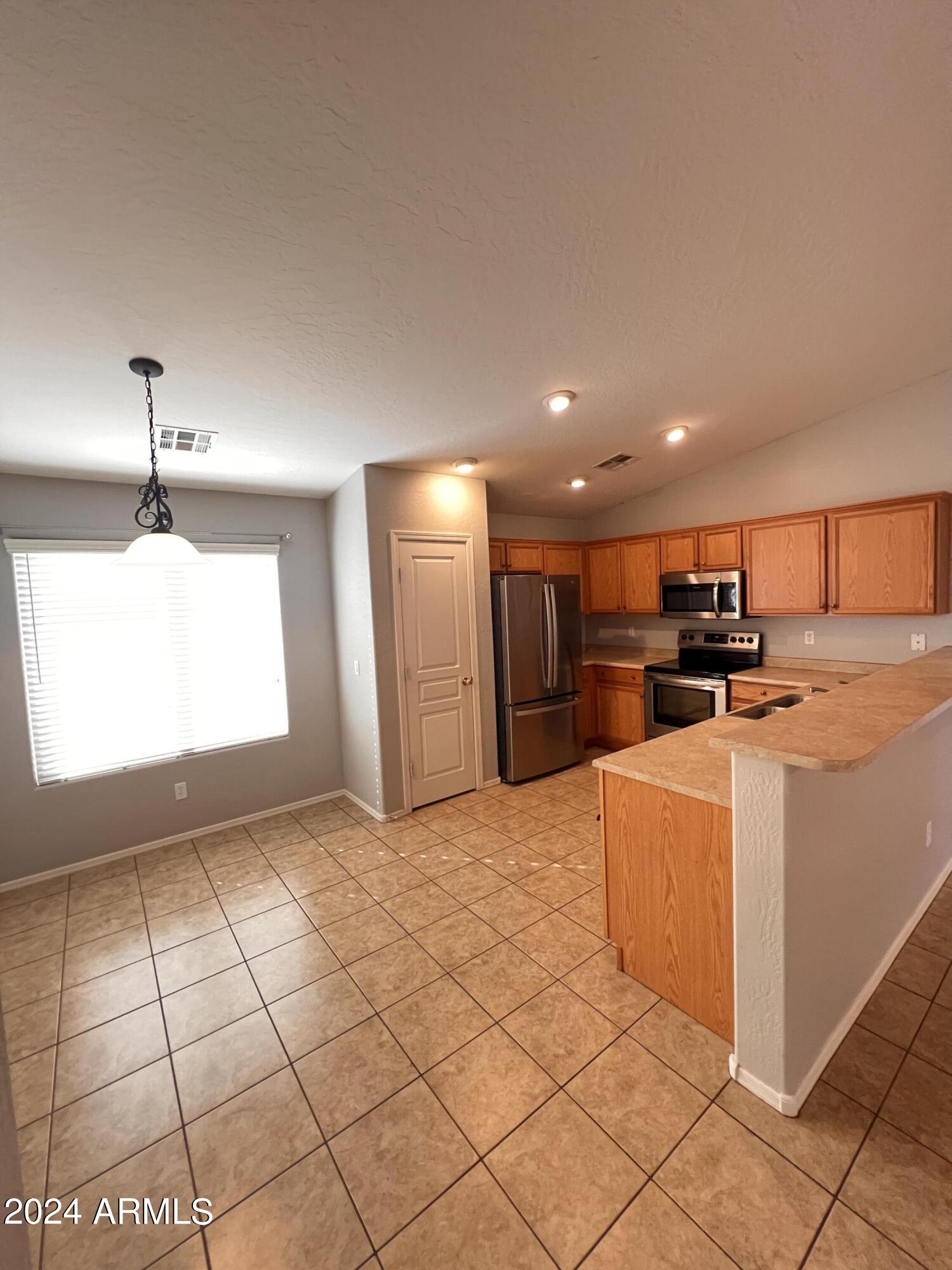 3797 East Ironhorse Road Gilbert, AZ 85297 - Photo 8 of 22 a view of kitchen appliances with cabinets