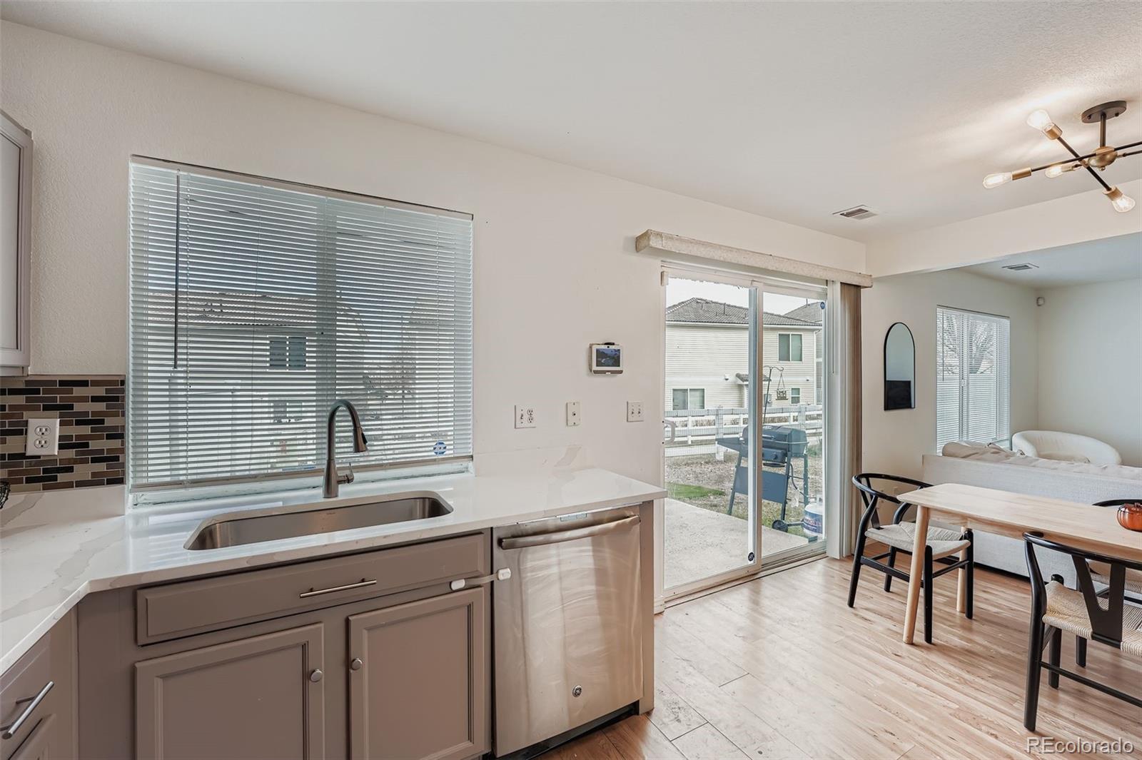 4250 Perth Circle Denver, CO 80249 - Photo 11 of 31 a kitchen with a sink cabinets and wooden floor