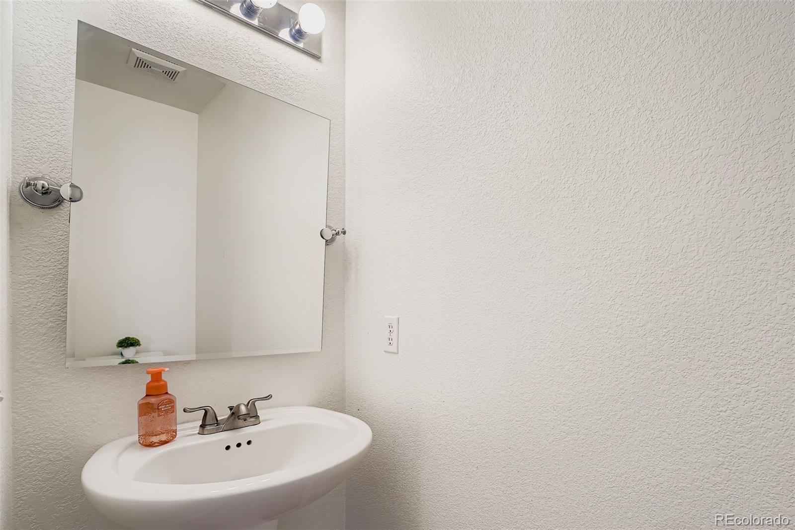 4250 Perth Circle Denver, CO 80249 - Photo 13 of 31 a white bath tub sitting in a bathroom