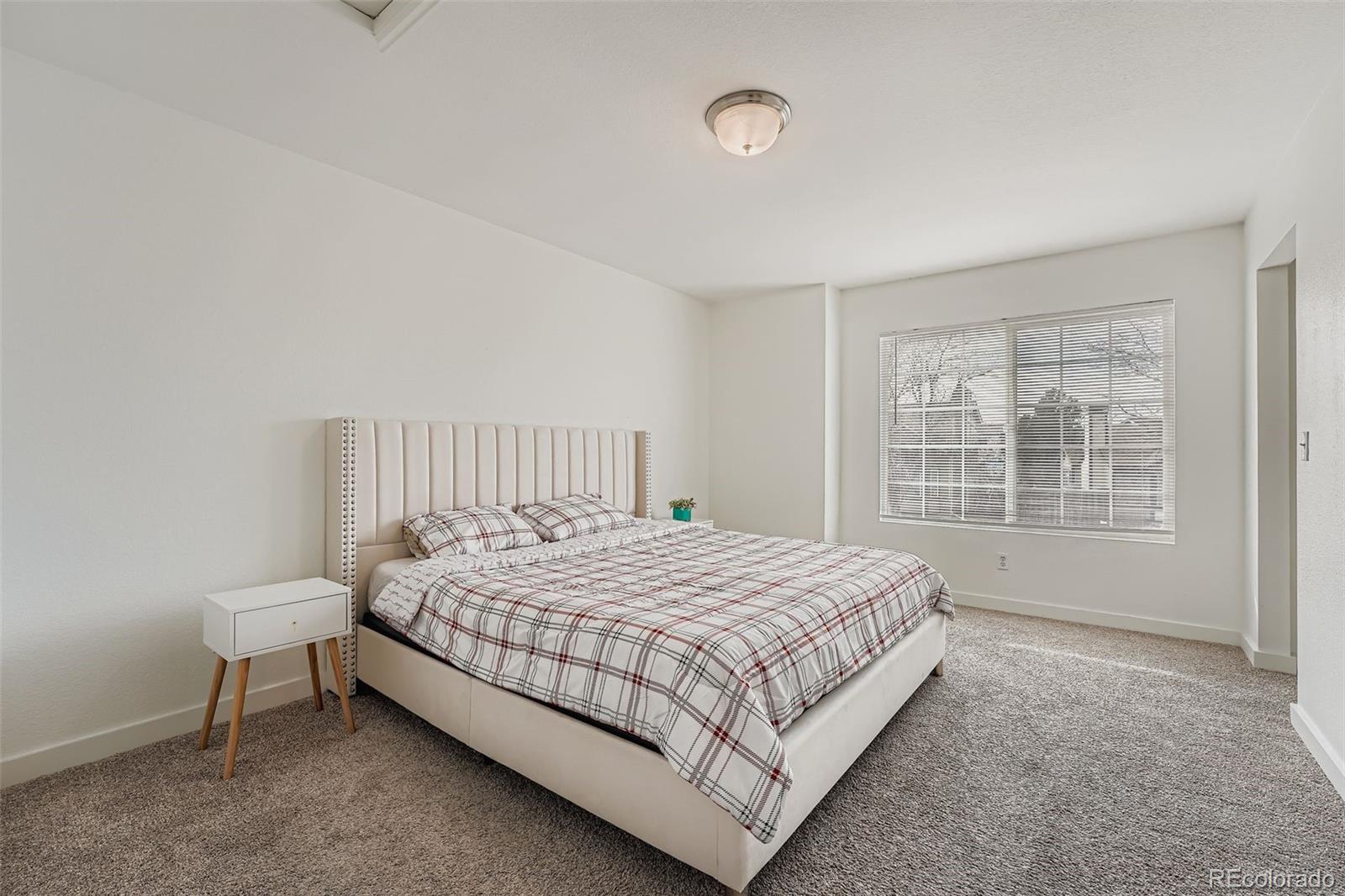 4250 Perth Circle Denver, CO 80249 - Photo 14 of 31 a bedroom with a bed and a window