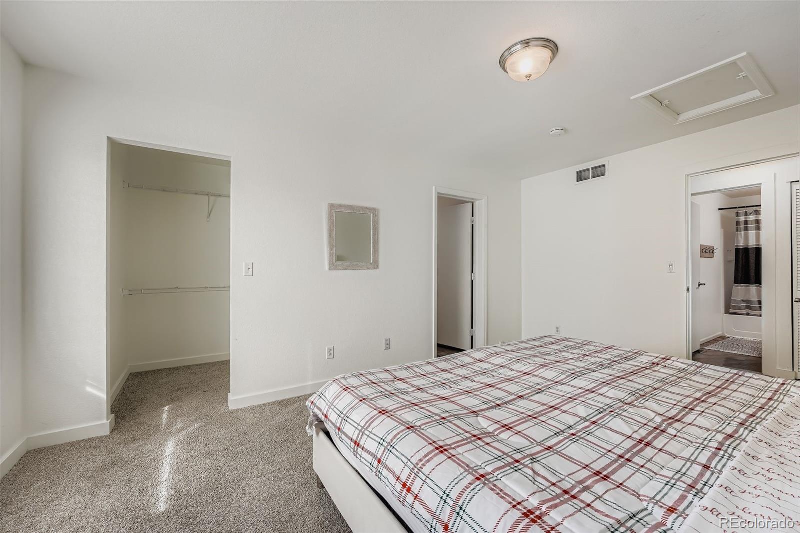 4250 Perth Circle Denver, CO 80249 - Photo 17 of 31 a bedroom with a bed and closet