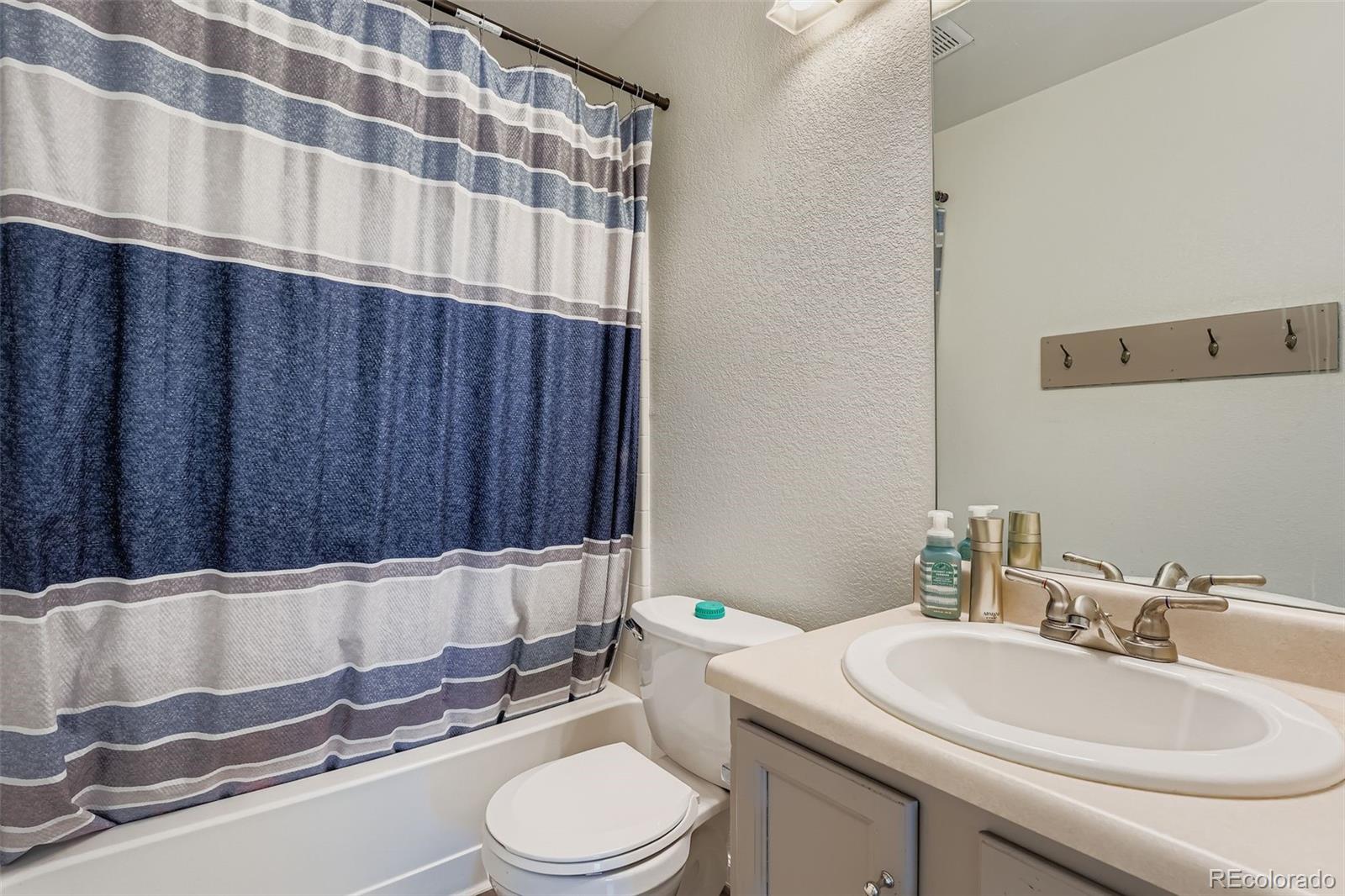 4250 Perth Circle Denver, CO 80249 - Photo 26 of 31 a bathroom with a sink a toilet and tub