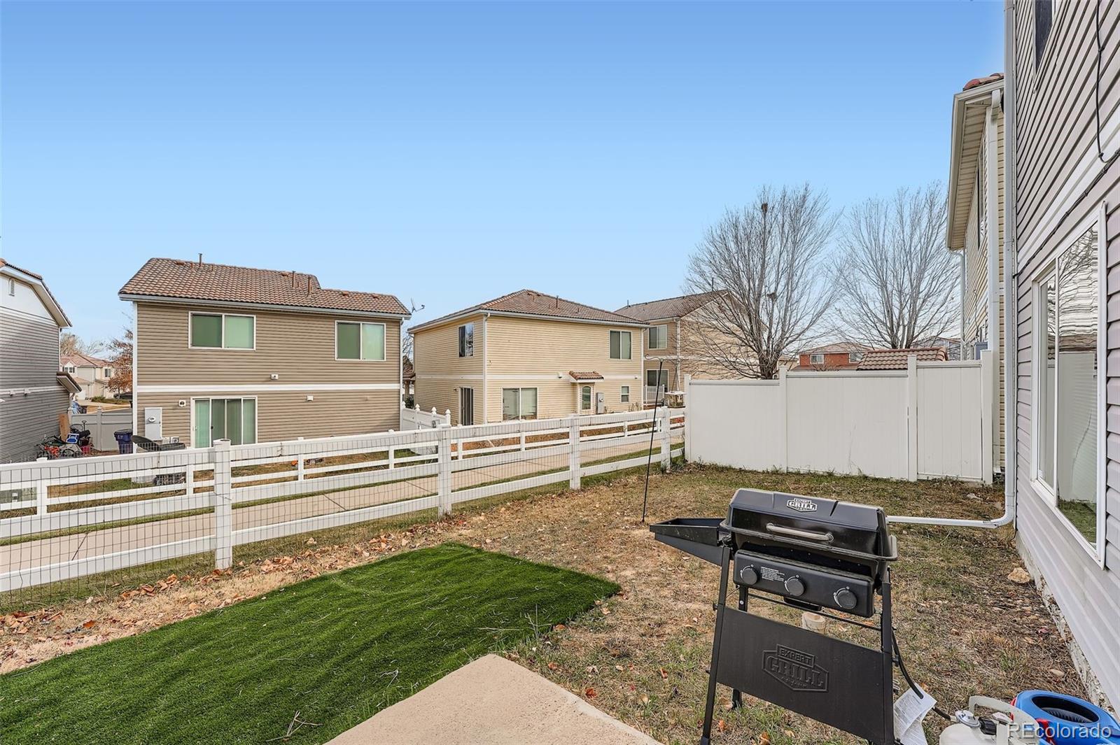 4250 Perth Circle Denver, CO 80249 - Photo 27 of 31 front view of a house with a yard