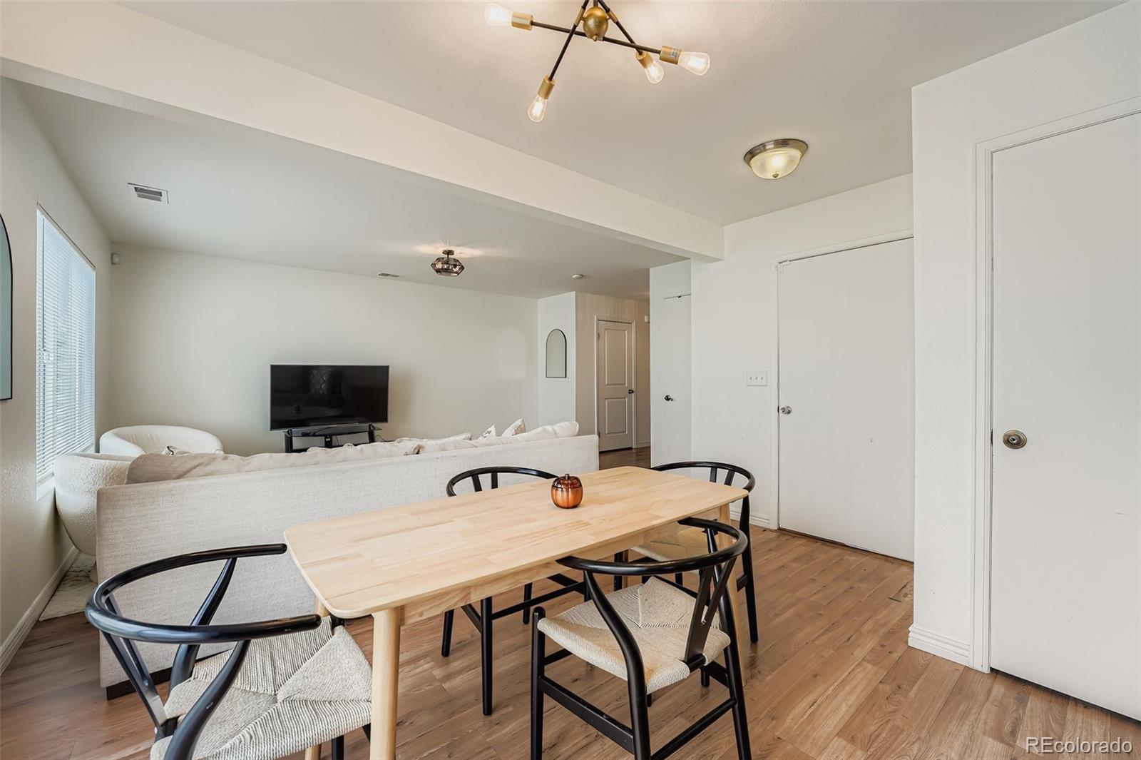 4250 Perth Circle Denver, CO 80249 - Photo 8 of 31 a view of a dining room with furniture and wooden floor
