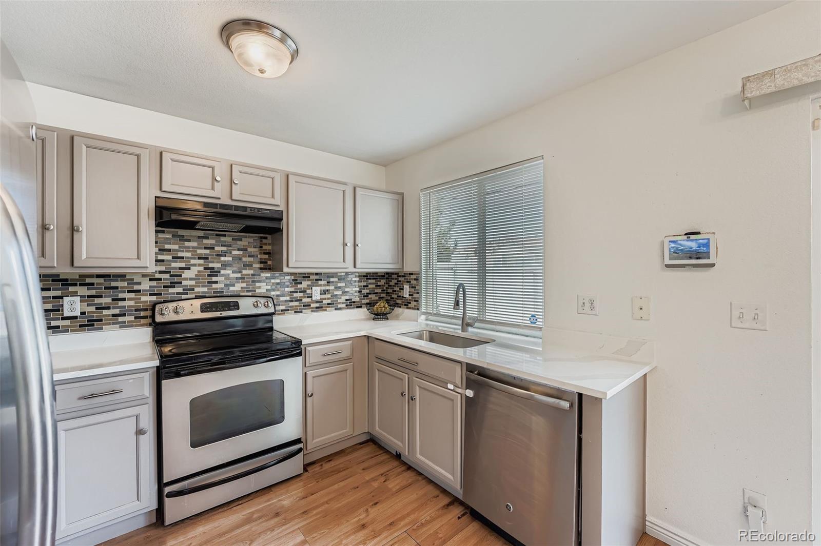4250 Perth Circle Denver, CO 80249 - Photo 10 of 31 a kitchen with cabinets stainless steel appliances and sink