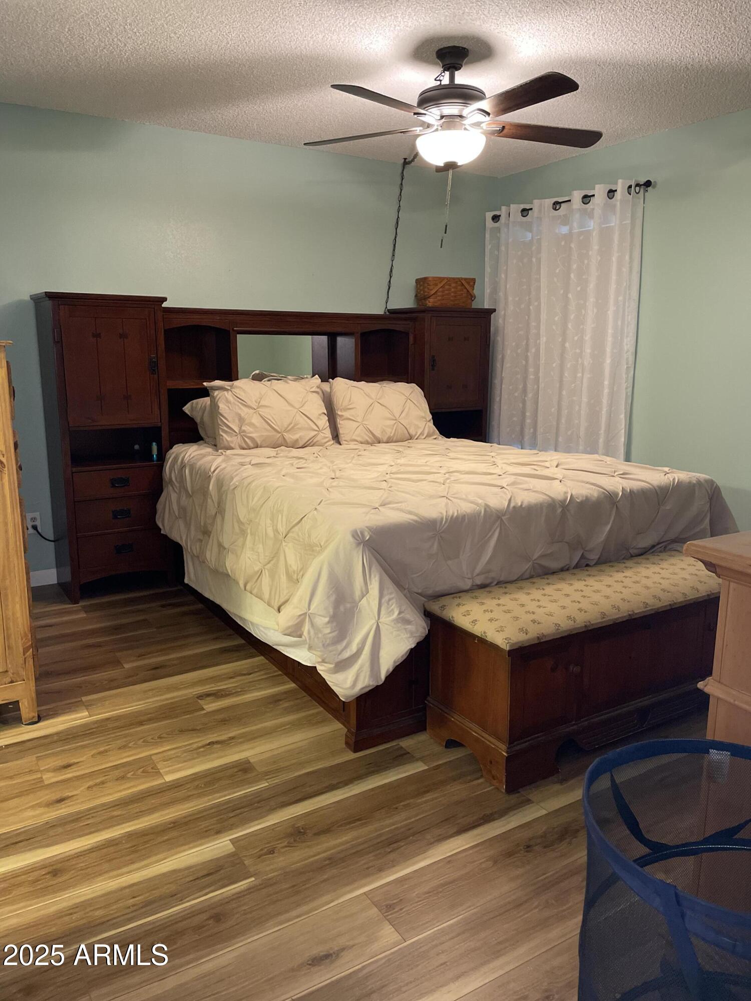 455 South Delaware Drive, Unit 171 Apache Junction, AZ 85120 - Photo 12 of 20 a bedroom with a bed and a chandelier