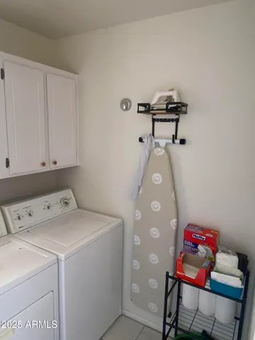 a patio with a table and chairs under an umbrella