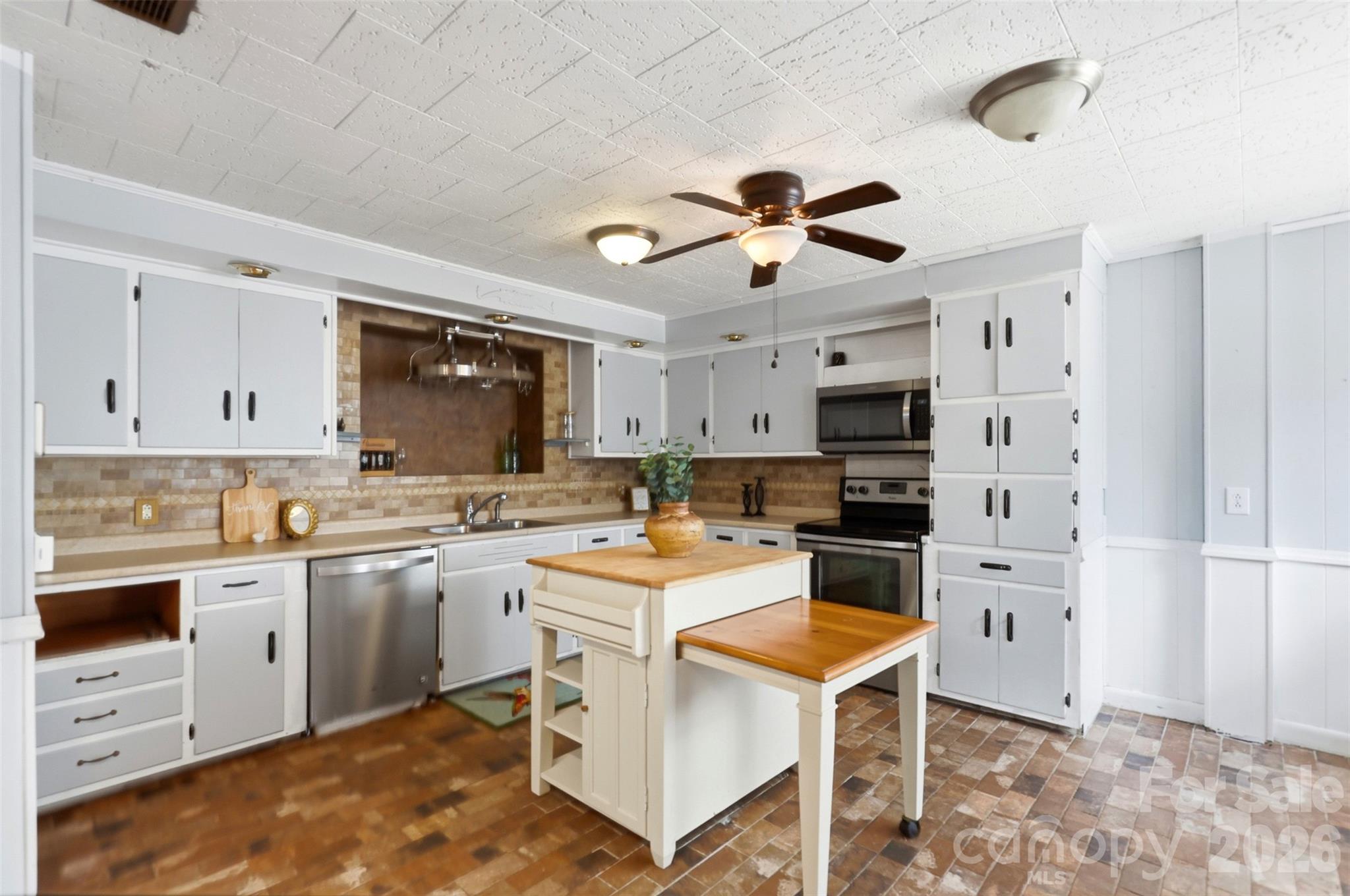 2670 North Olivers Road Newton, NC 28658 - Photo 12 of 27 a kitchen with a stove a sink and a refrigerator