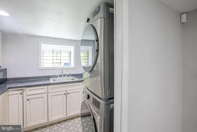 a kitchen with a sink cabinets and window