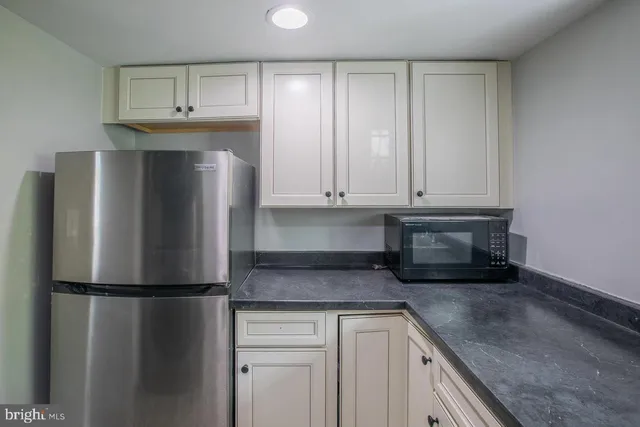 a view of an empty room and a bathroom