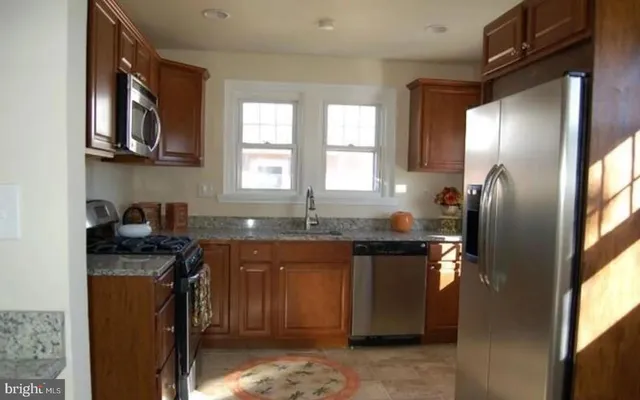 a living room with furniture and a lamp