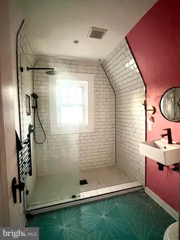 a bathroom with a mirror and a shower