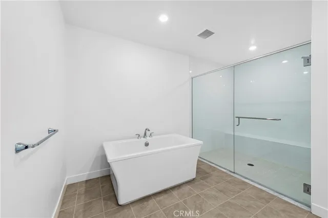 a white bath tub sitting next to a shower